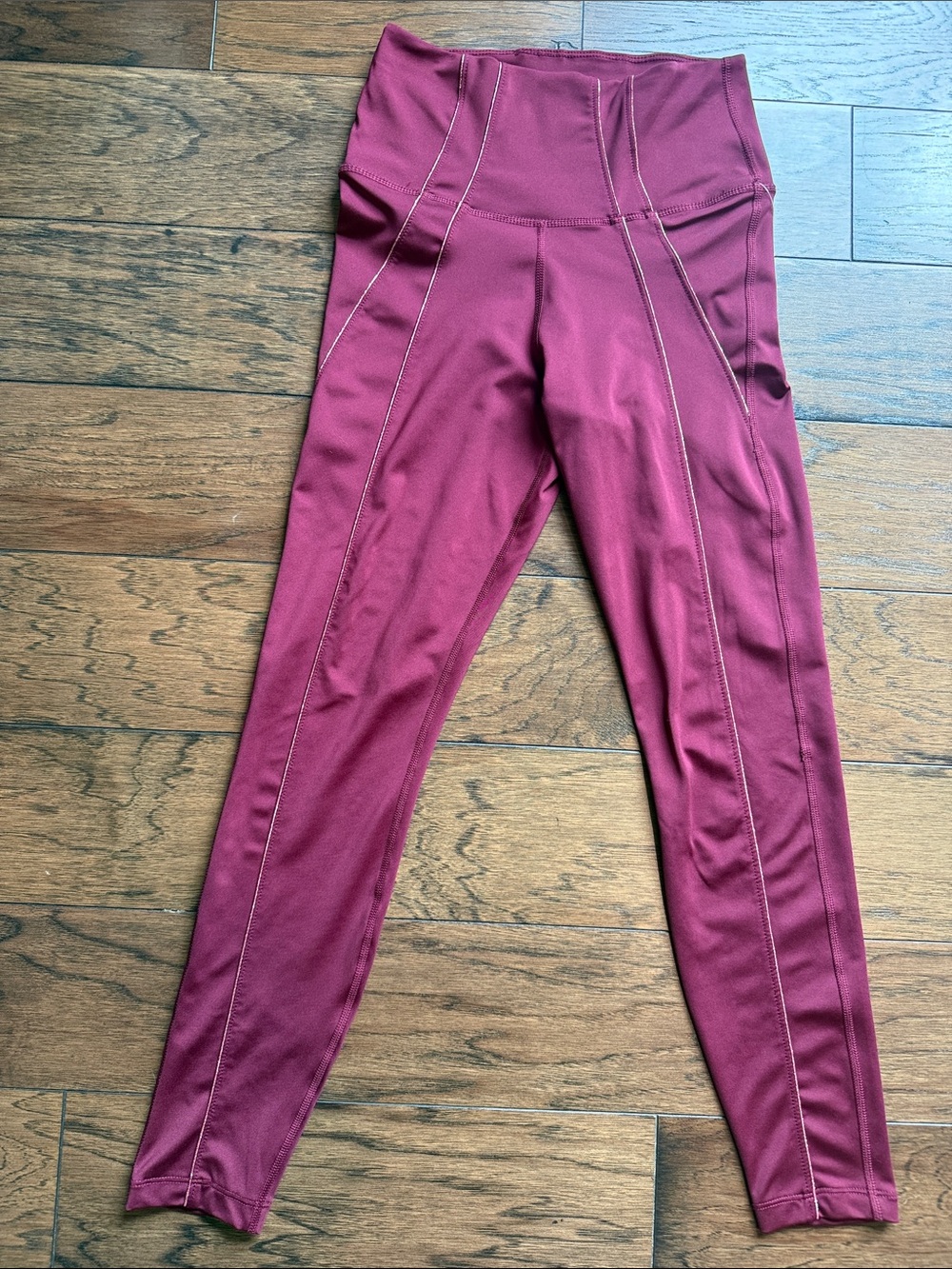NWOT. LIMITED EDITION Nike Dri Fit maroon leggings wirh gold flattering details